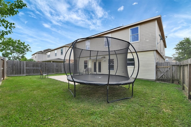 6706 Lindale Manor Ct, Spring, TX 77379 - rear view of property featuring a trampoline and a fenced backyard