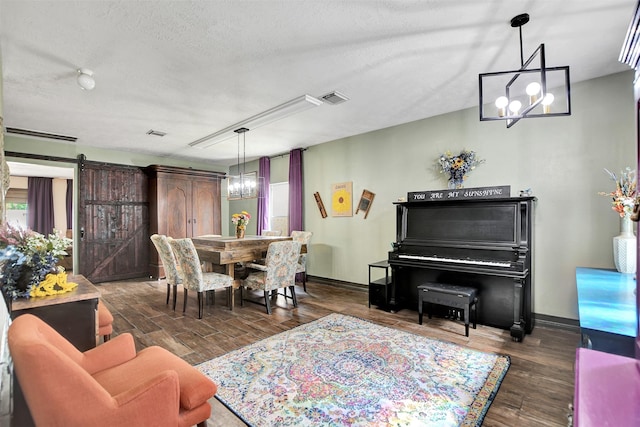 6706 Lindale Manor Ct, Spring, TX 77379 - dining room featuring a chandelier, a barn door, wood finished floors, and a textured ceiling