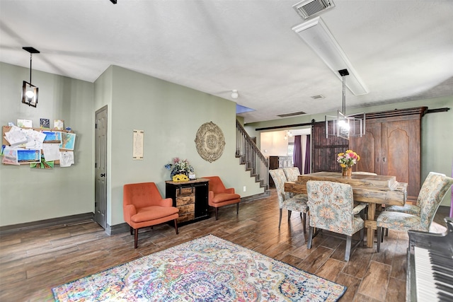 6706 Lindale Manor Ct, Spring, TX 77379 - dining area featuring wood finished floors, a barn door, and stairs