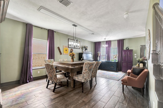 6706 Lindale Manor Ct, Spring, TX 77379 - dining space with wood finished floors, a textured ceiling, and a chandelier