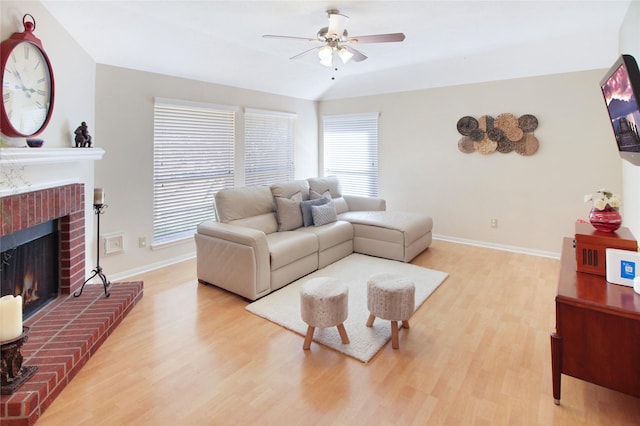 3334 Barkers Forest Ln, Houston, TX 77084 - living area featuring a ceiling fan, light wood-style flooring, baseboards, and a fireplace