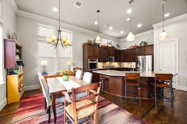 1616 Wrenwood Lks, Houston, TX 77043 - kitchen featuring stainless steel appliances, a sink, crown molding, dark wood finished floors, and a chandelier