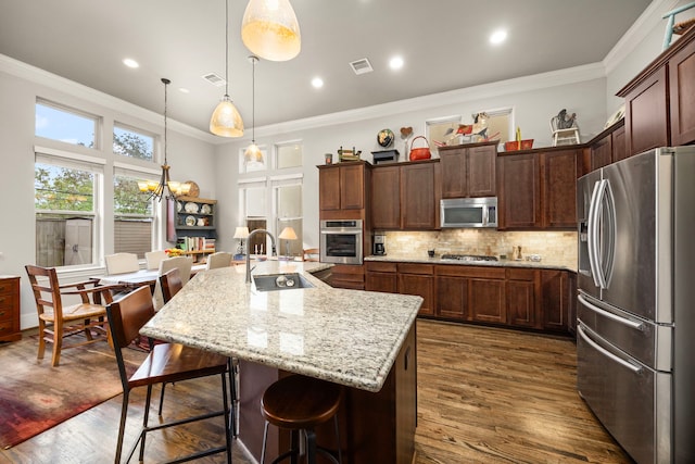 1616 Wrenwood Lks, Houston, TX 77043 - kitchen with stainless steel appliances, a sink, dark wood-style flooring, a chandelier, and crown molding