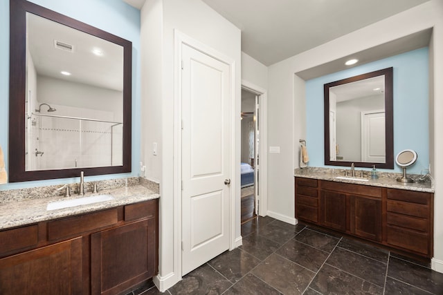 1616 Wrenwood Lks, Houston, TX 77043 - ensuite bathroom featuring two vanities, baseboards, tiled shower, and recessed lighting