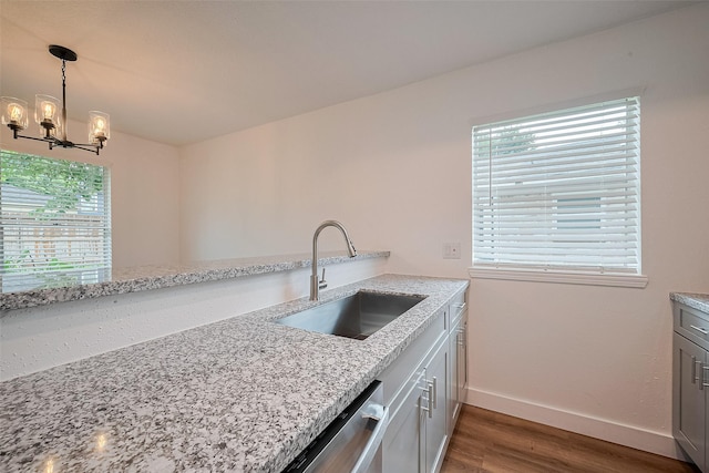 19803 Packwood Dr, Katy, TX 77449 - kitchen with wood finished floors, a chandelier, plenty of natural light, and light stone counters