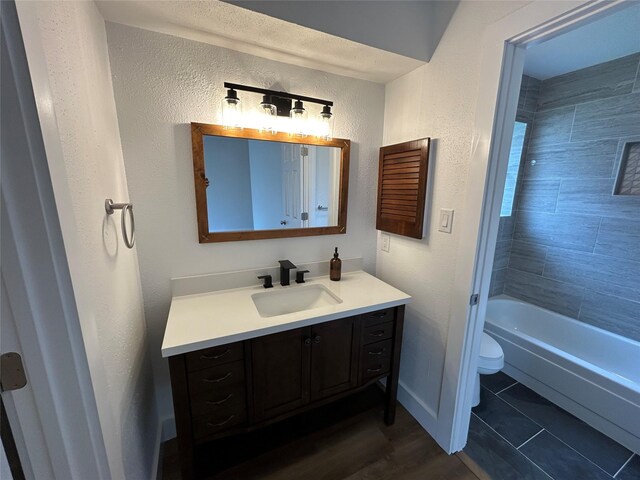 19803 Packwood Dr, Katy, TX 77449 - full bathroom with vanity, a textured wall, and shower / bath combination