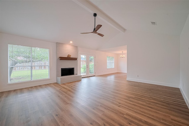 19803 Packwood Dr, Katy, TX 77449 - unfurnished living room with wood finished floors, a ceiling fan, a chandelier, and a brick fireplace