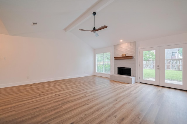 19803 Packwood Dr, Katy, TX 77449 - unfurnished living room featuring light wood-style floors, ceiling fan, french doors, and a brick fireplace