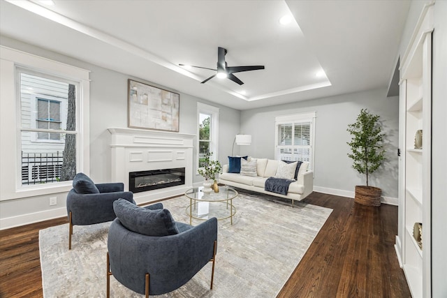 1819 Oxford St, Houston, TX 77008 - living room with a raised ceiling, ceiling fan, dark wood-style floors, a glass covered fireplace, and recessed lighting