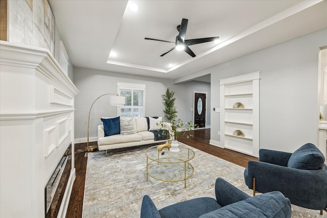 1819 Oxford St, Houston, TX 77008 - living area with a ceiling fan, dark wood-style floors, built in features, a tray ceiling, and recessed lighting
