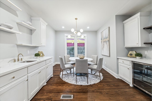 1819 Oxford St, Houston, TX 77008 - dining room featuring wine cooler, dark wood-style flooring, recessed lighting, and a chandelier