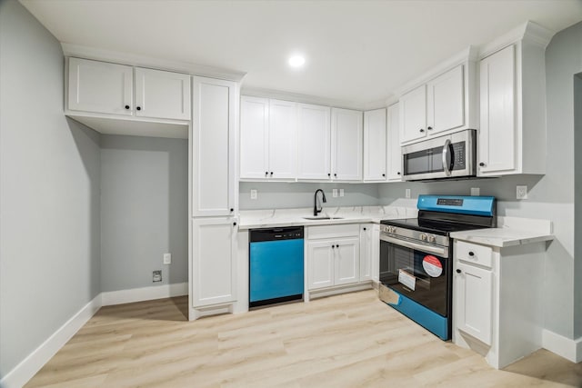 1819 Oxford St, Houston, TX 77008 - kitchen featuring stainless steel appliances, white cabinets, light wood-type flooring, and recessed lighting
