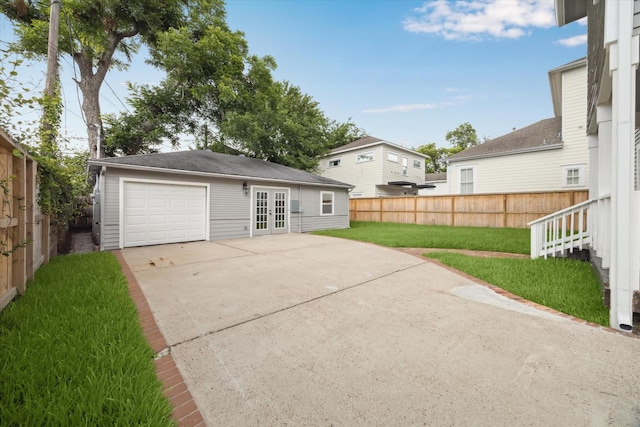 1819 Oxford St, Houston, TX 77008 - rear view of house featuring french doors, concrete driveway, a fenced backyard, and a patio area