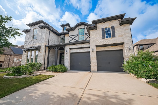 18003 Winding Willow Oak Way, Cypress, TX 77433 - view of front facade with driveway, a garage, and stone siding