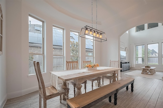 18003 Winding Willow Oak Way, Cypress, TX 77433 - dining room featuring arched walkways and light wood finished floors