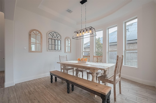 18003 Winding Willow Oak Way, Cypress, TX 77433 - dining space with a raised ceiling, light wood finished floors, crown molding, and a chandelier
