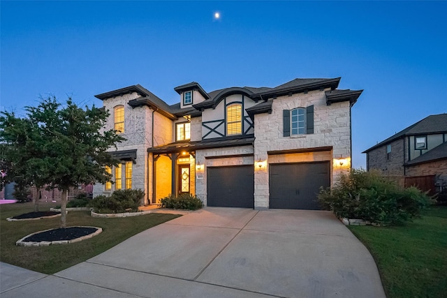 18003 Winding Willow Oak Way, Cypress, TX 77433 - view of front of house featuring stone siding, a garage, driveway, and a front lawn
