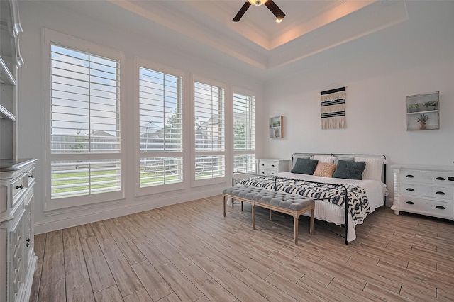 18003 Winding Willow Oak Way, Cypress, TX 77433 - bedroom with a tray ceiling, light wood-type flooring, and ceiling fan