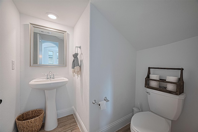18003 Winding Willow Oak Way, Cypress, TX 77433 - half bathroom featuring wood finished floors and vaulted ceiling