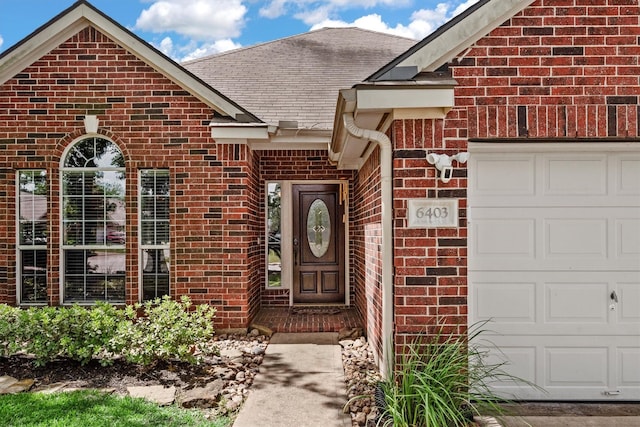 6403 Sagewalk Ct, Spring, TX 77379 - doorway to property featuring brick siding, an attached garage, and a shingled roof
