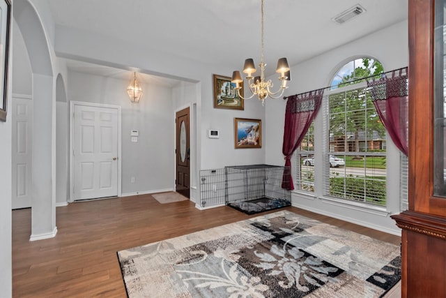 6403 Sagewalk Ct, Spring, TX 77379 - dining space with a chandelier, arched walkways, wood finished floors, and baseboards
