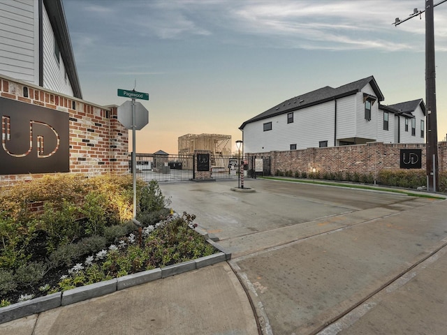9221 Washington Hts, Houston, TX 77063 - view of concrete road with a gate, curbs, traffic signs, and a gated entry