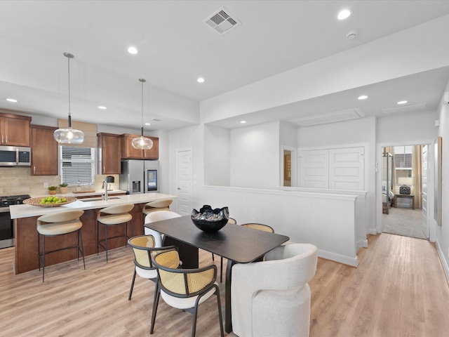 9221 Washington Hts, Houston, TX 77063 - dining space with light wood-style flooring, recessed lighting, baseboards, and plenty of natural light