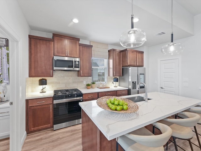 9221 Washington Hts, Houston, TX 77063 - kitchen with appliances with stainless steel finishes, a sink, backsplash, and light wood-style flooring
