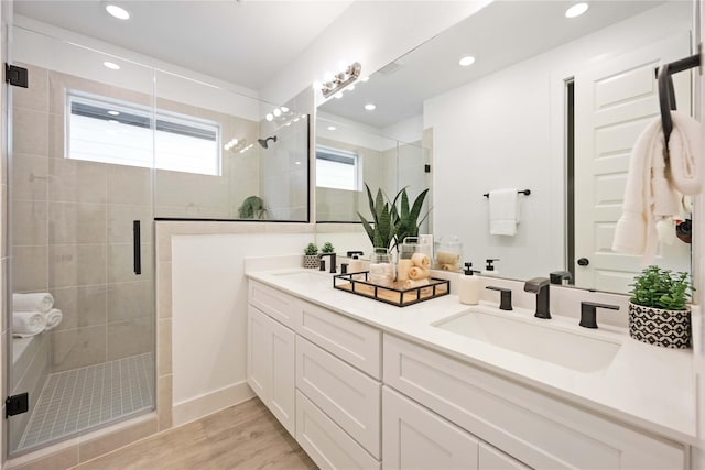 5322 Rue St, Houston, TX 77033 - full bath with a stall shower, double vanity, wood finished floors, and recessed lighting