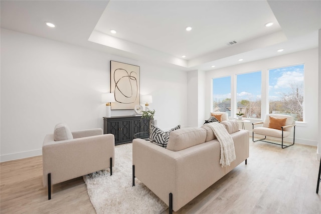 5322 Rue St, Houston, TX 77033 - living area with a tray ceiling, light wood finished floors, recessed lighting, and baseboards