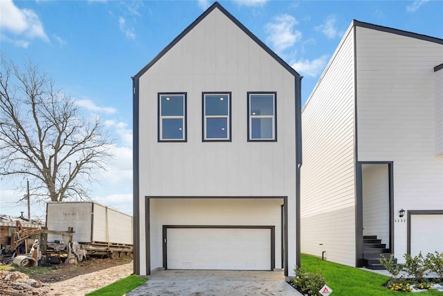 5324 Rue St, Houston, TX 77033 - view of front of home with board and batten siding, an attached garage, and driveway