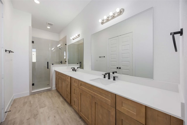 5324 Rue St, Houston, TX 77033 - full bath with double vanity, a stall shower, wood finished floors, baseboards, and recessed lighting