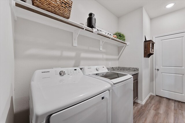 16997 White Birch Ln, Conroe, TX 77385 - laundry room with cabinet space, light wood-style floors, washing machine and clothes dryer, baseboards, and recessed lighting