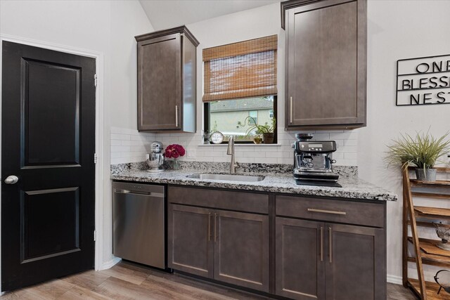 16997 White Birch Ln, Conroe, TX 77385 - kitchen with stainless steel dishwasher, a sink, dark brown cabinets, and backsplash