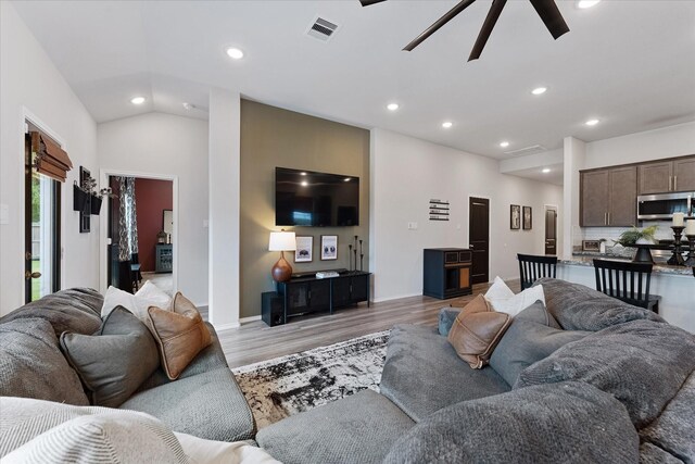 16997 White Birch Ln, Conroe, TX 77385 - living room with light wood-style floors, ceiling fan, recessed lighting, baseboards, and lofted ceiling