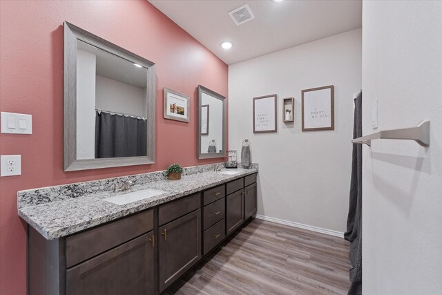 16997 White Birch Ln, Conroe, TX 77385 - full bathroom featuring double vanity, wood finished floors, baseboards, and recessed lighting