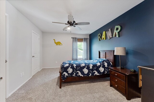 16997 White Birch Ln, Conroe, TX 77385 - bedroom with light colored carpet, baseboards, and a ceiling fan