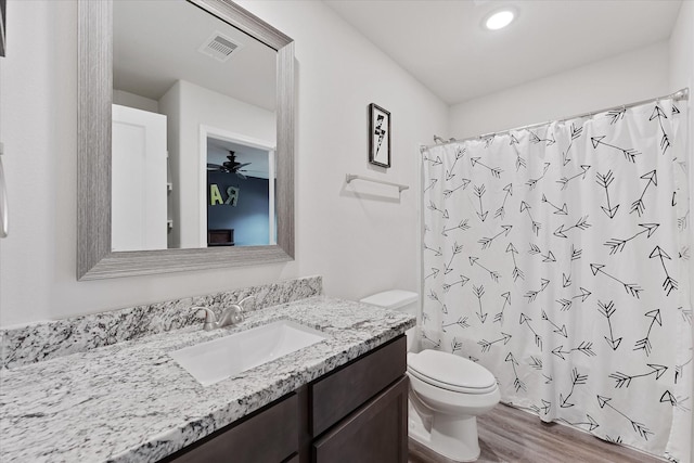 16997 White Birch Ln, Conroe, TX 77385 - bathroom featuring toilet, vanity, wood finished floors, and curtained shower