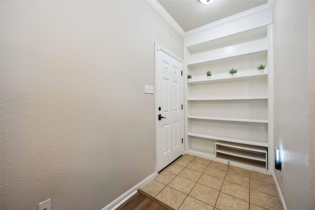 2255 Braeswood Park Dr Unit 105, Houston, TX 77030 - entryway featuring crown molding, baseboards, and light tile patterned floors