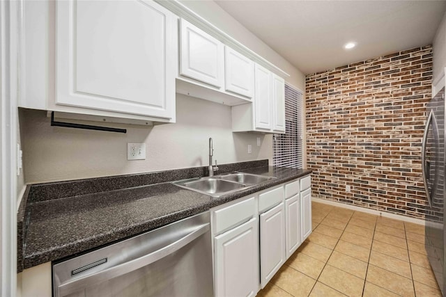 2255 Braeswood Park Dr Unit 105, Houston, TX 77030 - kitchen with dishwasher, a sink, brick wall, white cabinets, and dark countertops