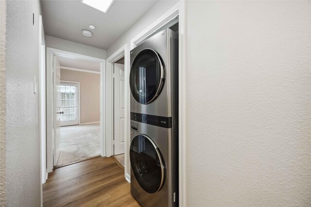 2255 Braeswood Park Dr Unit 105, Houston, TX 77030 - laundry area with estacked washer and dryer and wood finished floors