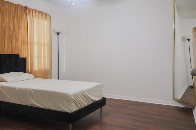 1007 Prune St, La Marque, TX 77568 - bedroom featuring dark wood-type flooring and baseboards