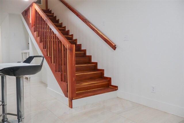 1007 Prune St, La Marque, TX 77568 - stairs featuring baseboards and tile patterned floors