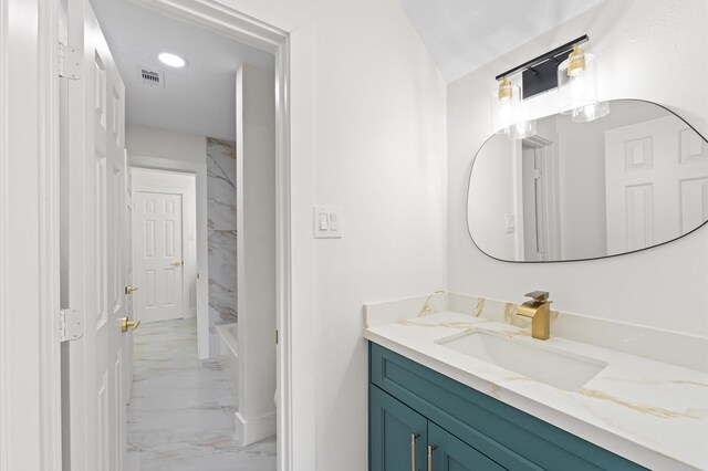 31318 Bearing Star Ln, Tomball, TX 77375 - full bathroom with marble look tiles, vanity, and baseboards