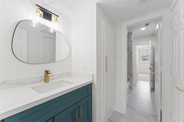 31318 Bearing Star Ln, Tomball, TX 77375 - bathroom featuring marble look tile flooring and vanity