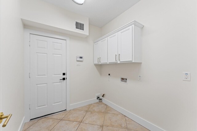31318 Bearing Star Ln, Tomball, TX 77375 - washroom with hookup for an electric dryer, washer hookup, gas dryer hookup, light tile patterned floors, and baseboards