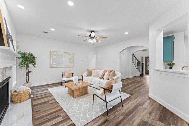 31318 Bearing Star Ln, Tomball, TX 77375 - living room featuring arched walkways, a premium fireplace, ceiling fan, recessed lighting, and wood finished floors