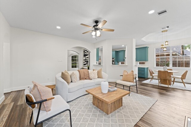 31318 Bearing Star Ln, Tomball, TX 77375 - living room with baseboards, wood finished floors, a ceiling fan, arched walkways, and recessed lighting