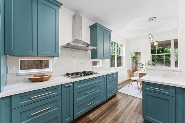 31318 Bearing Star Ln, Tomball, TX 77375 - kitchen with wall chimney exhaust hood, stainless steel gas stovetop, dark wood-type flooring, decorative backsplash, and pendant lighting