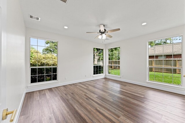 31318 Bearing Star Ln, Tomball, TX 77375 - unfurnished room with wood finished floors, plenty of natural light, baseboards, and recessed lighting